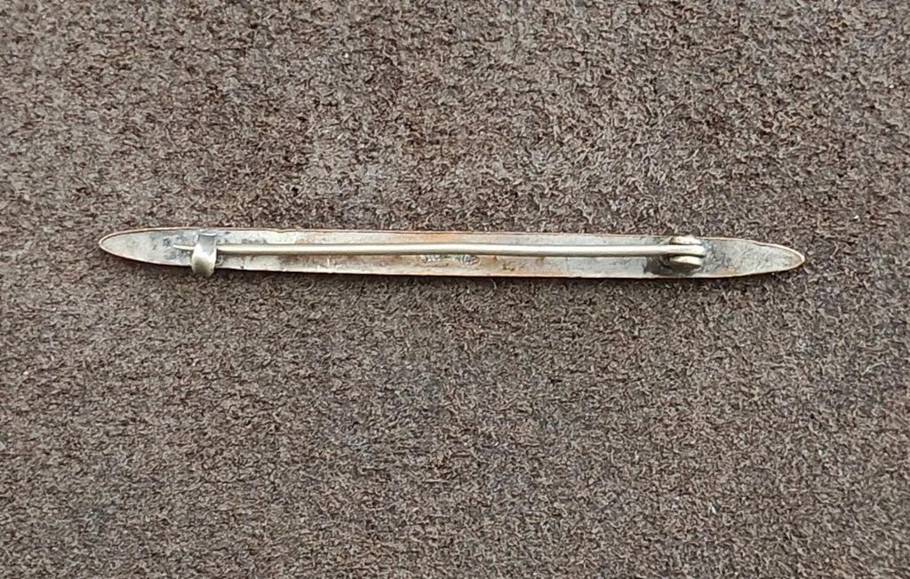 Silver bar brooch back with pin and clasp hardware visible
