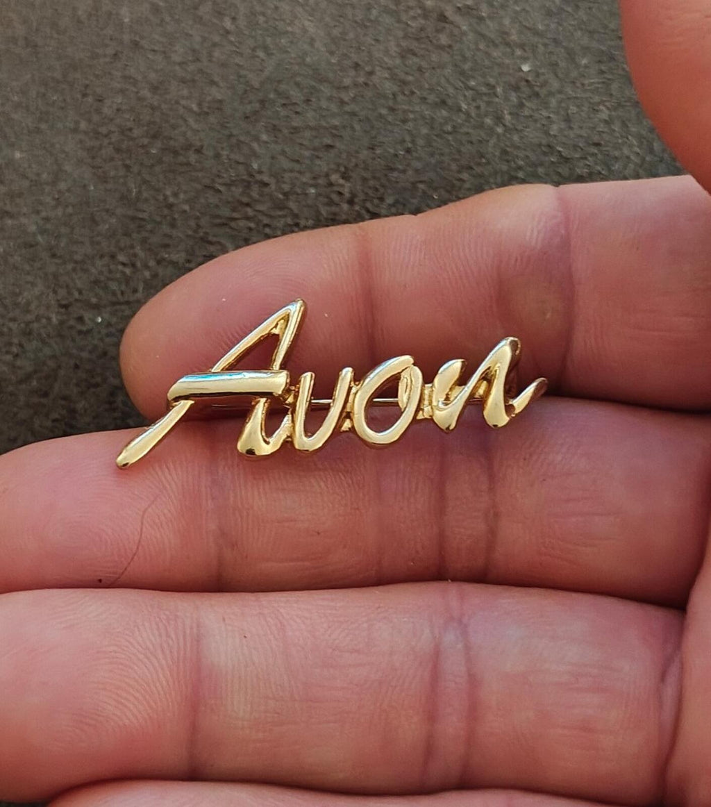 1980s/90s  Avon Gold Tone Cursive Logo Pin