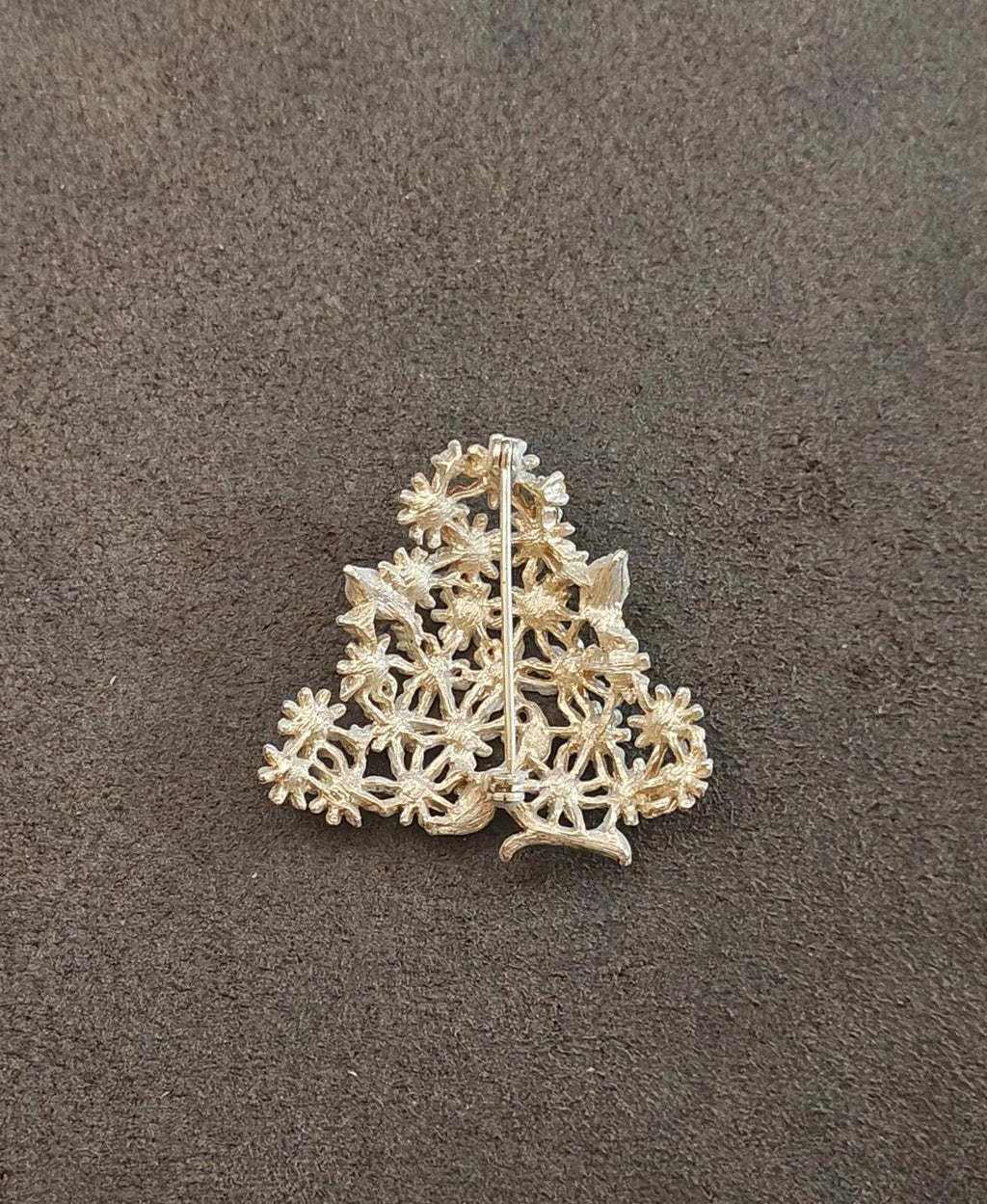 Gold-tone filigree brooch with intricate leaf-and-flower openwork design