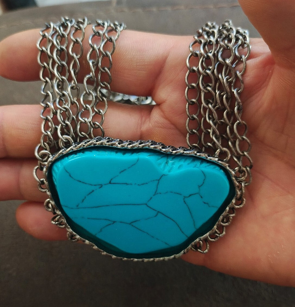 Silver Tone Multi Strand Chain Statement Necklace With a Faux Turquoise Stone