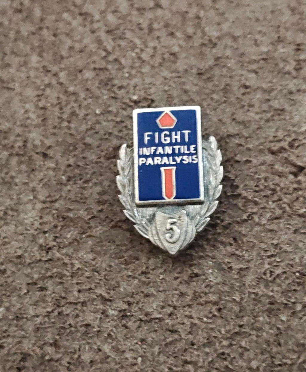 Silver-tone enamel badge pin with laurel leaves and “5” shield at bottom