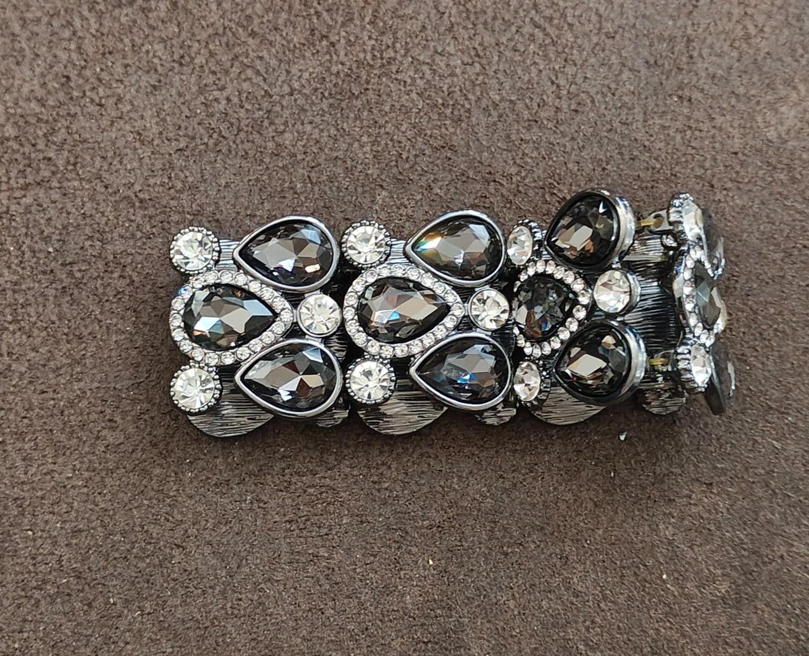Black stretch rhinestone bracelet with multi-pear stones and a silver-toned openwork band