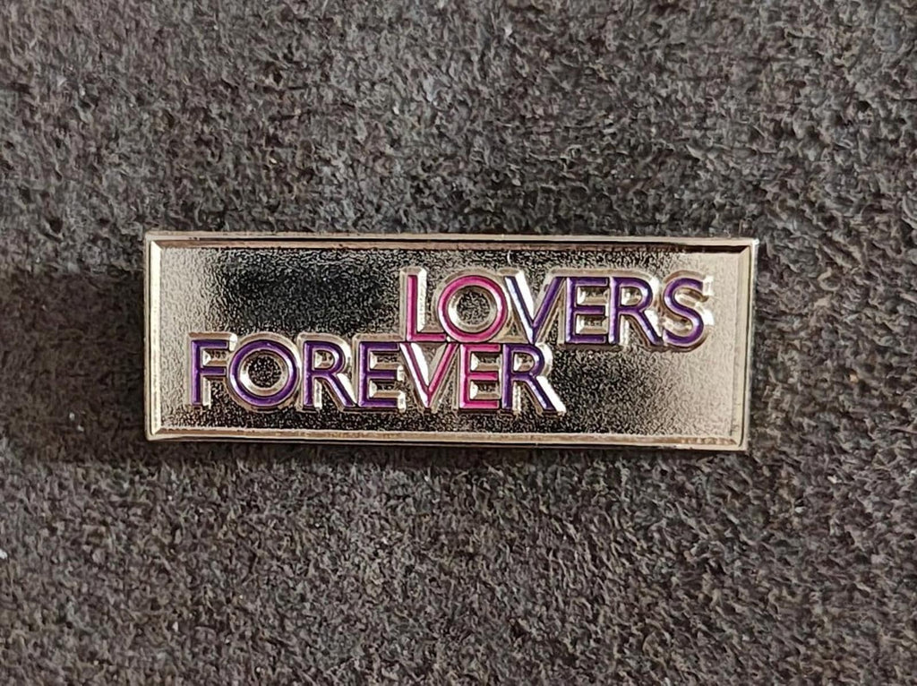 Gold-tone “Lovers Forever” enamel pin, centered front view with purple and pink text.