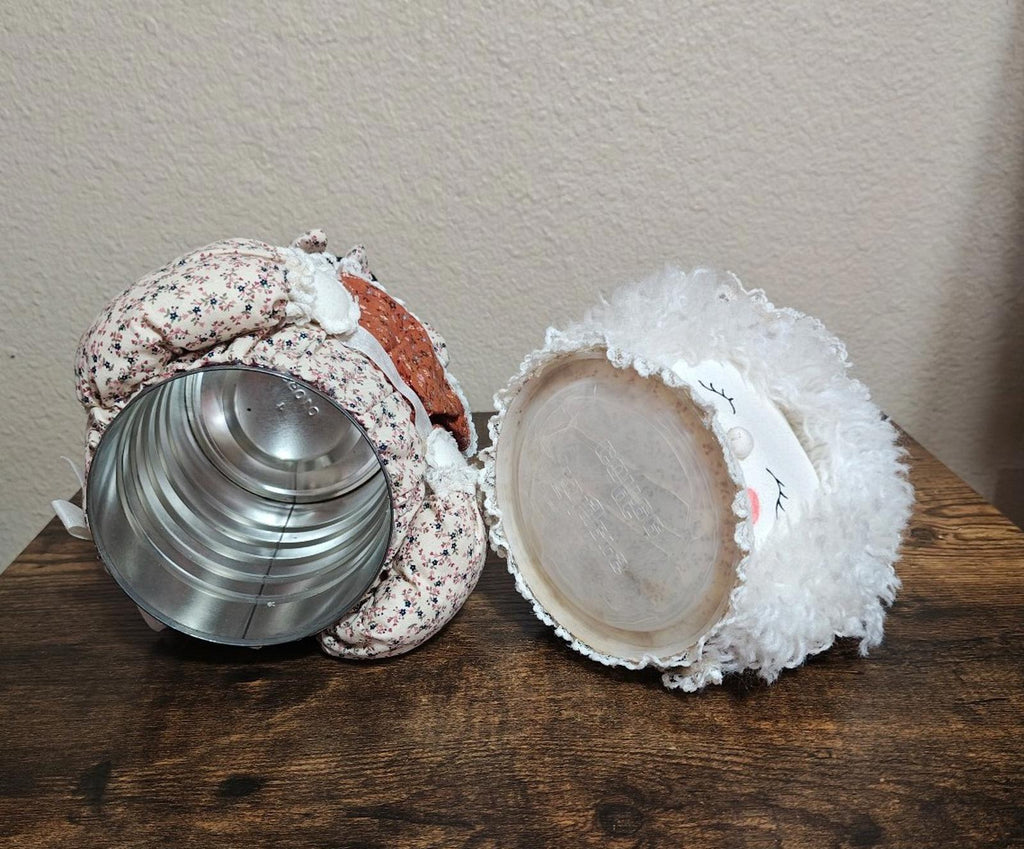 Handmade cloth doll canister with metal pot inside and open fabric lid, front view.