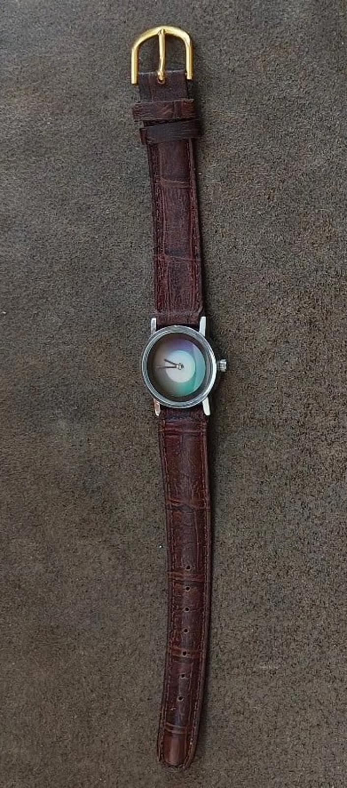 Brown leather wristwatch with gold-tone buckle and round dial case