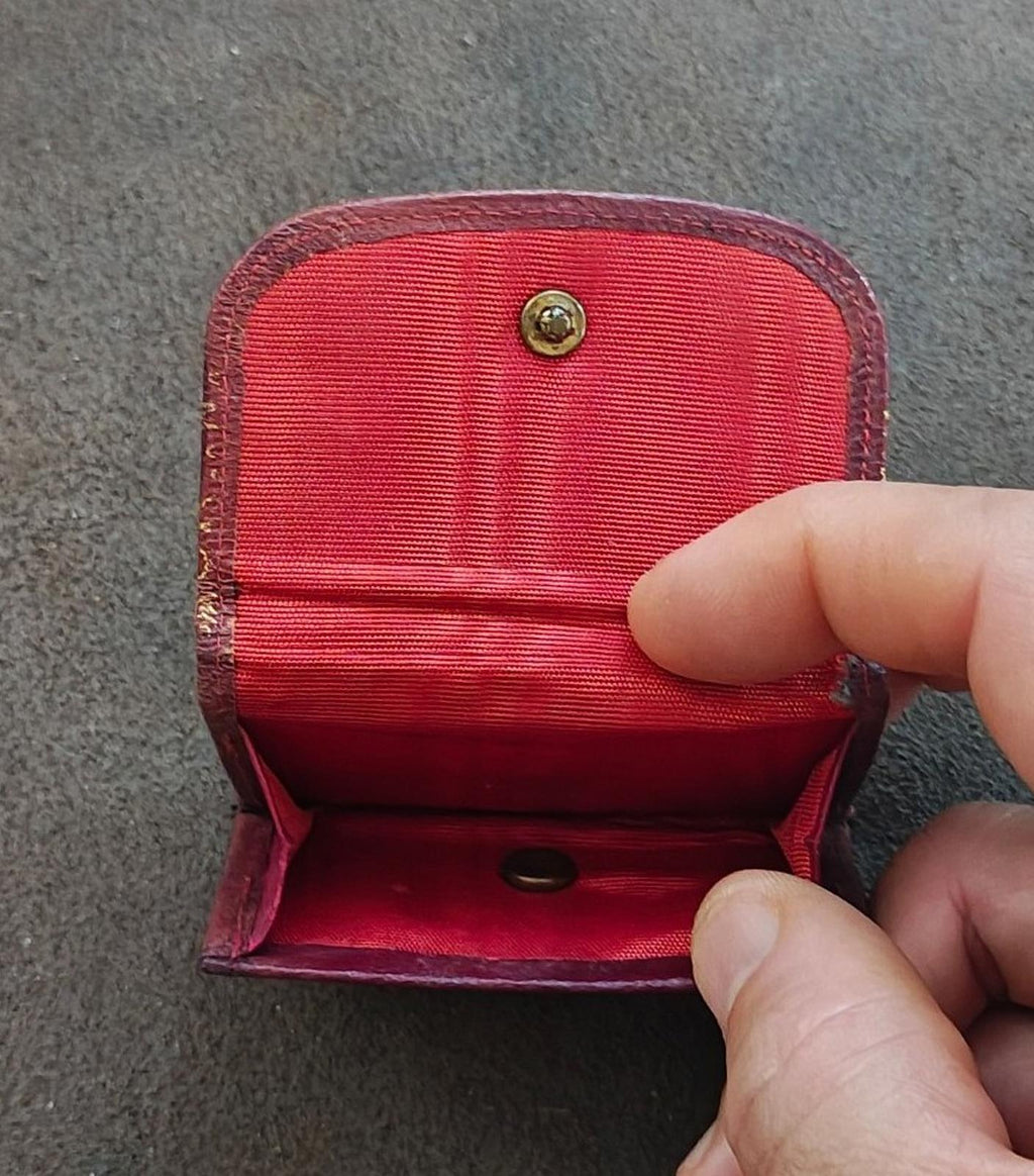 Coin purse wallet open view: red fabric lining, brass top snap, and small interior pocket.