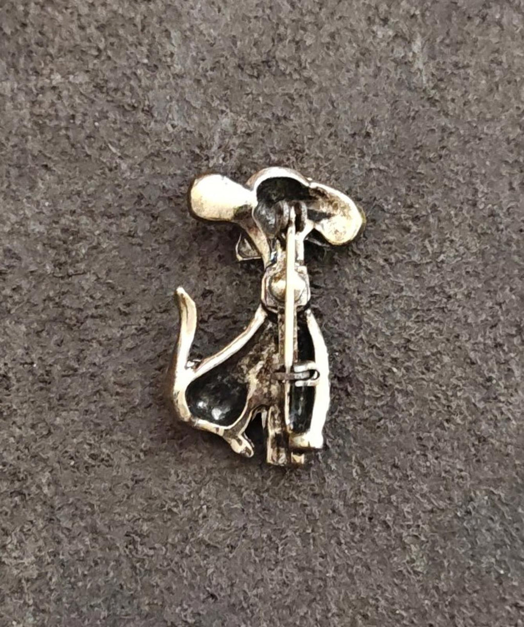 Gold-tone dog brooch back view with pin, clasp, and hinged mechanism