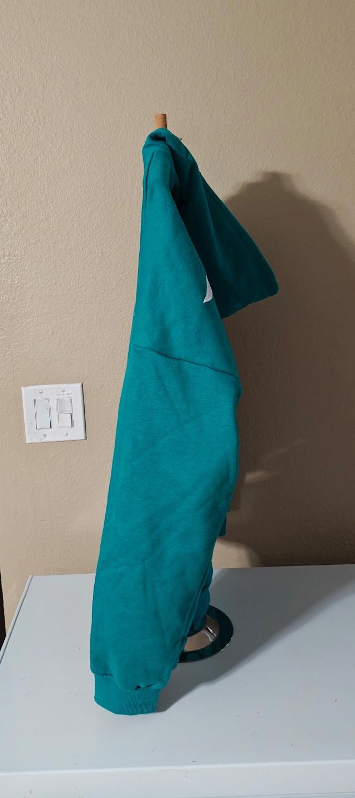 Teal hooded zip-up hoodie shown from the side