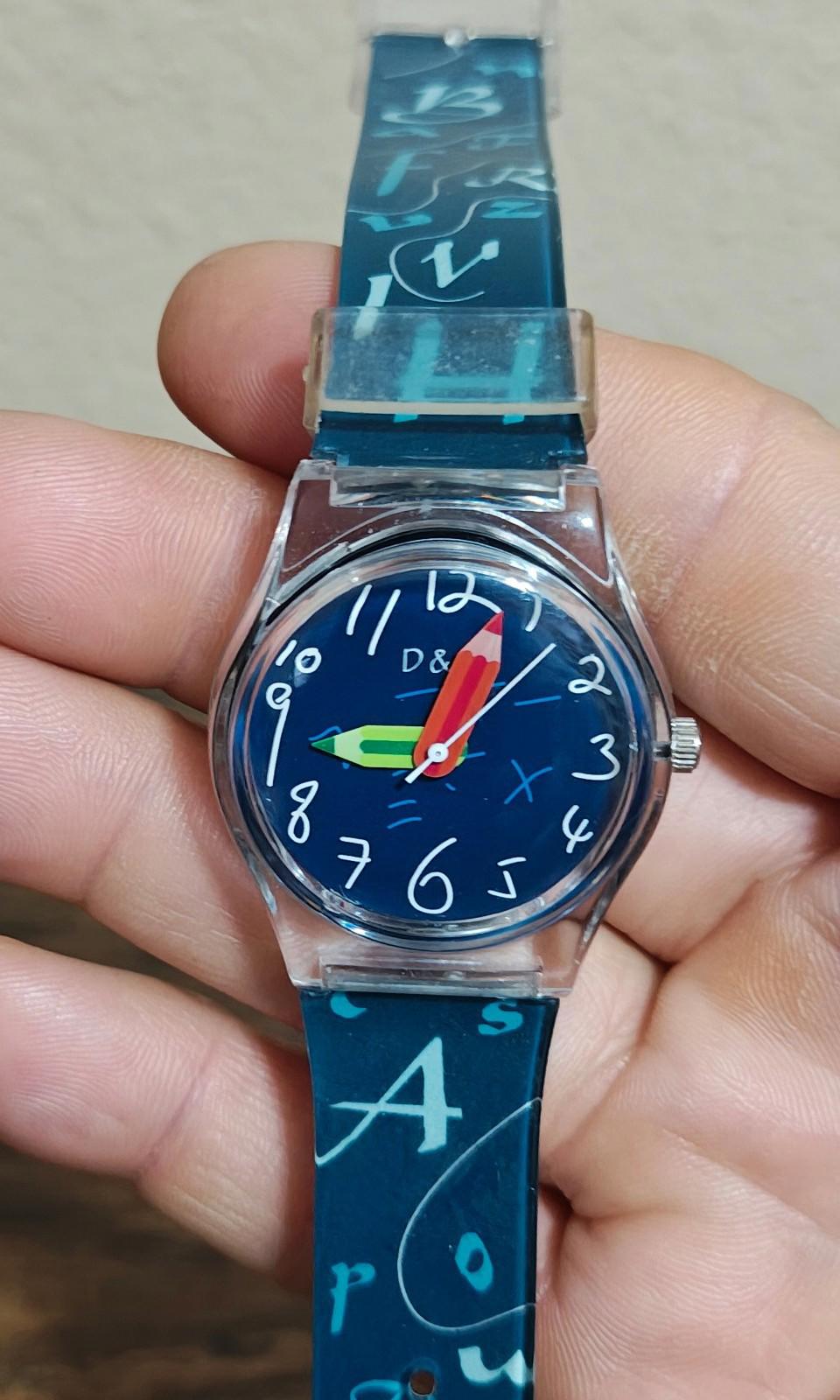 Blue unisex teacher watch with round blue dial, red hands, and printed letter strap