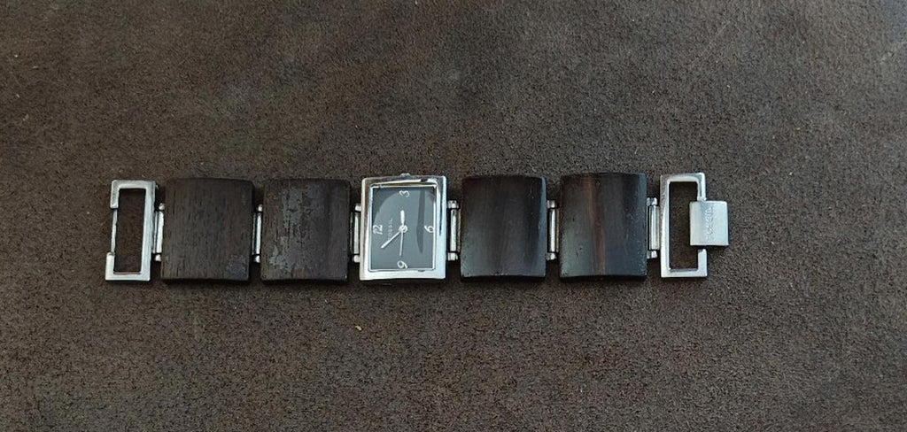 Ladies Fossil watch side view with silver hardware and brown wooden band links