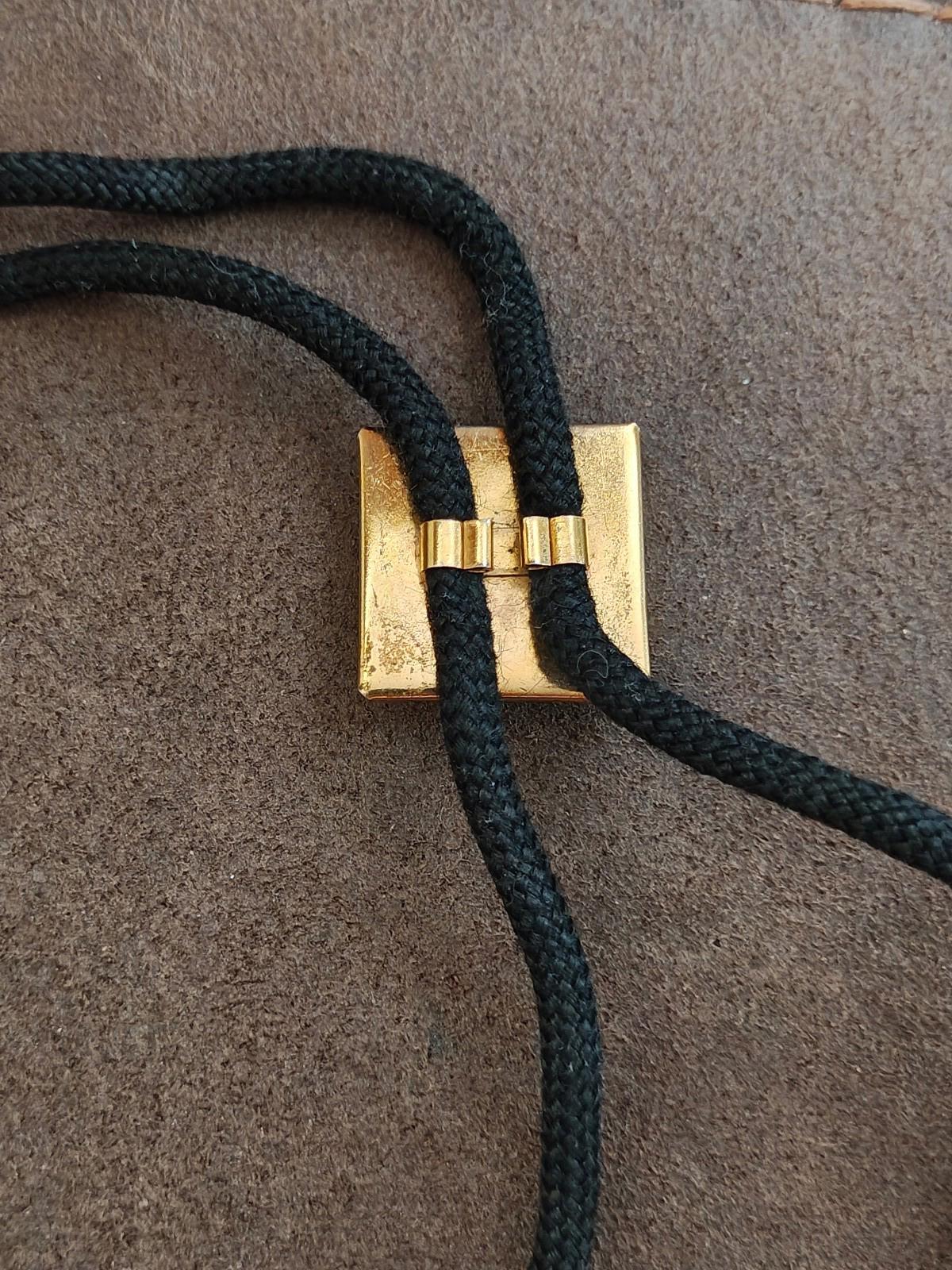 Gold connector and loop on black bolo tie cords