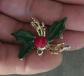 Holly enamel brooch pin with green leaves, red berries, and gold-tone accents