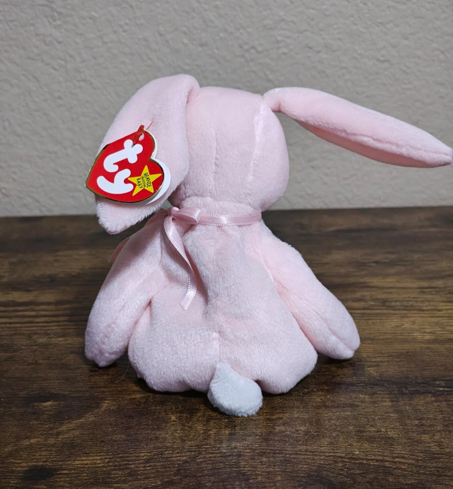 Pink plush bunny beanbag with heart-shaped TY tag and ribbon bow on back