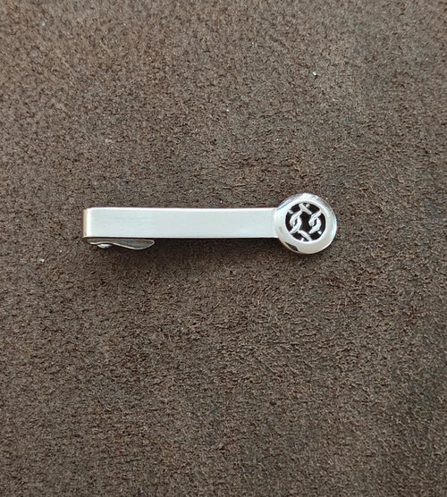 Silver tie bar clip, round Celtic knot medallion end visible
