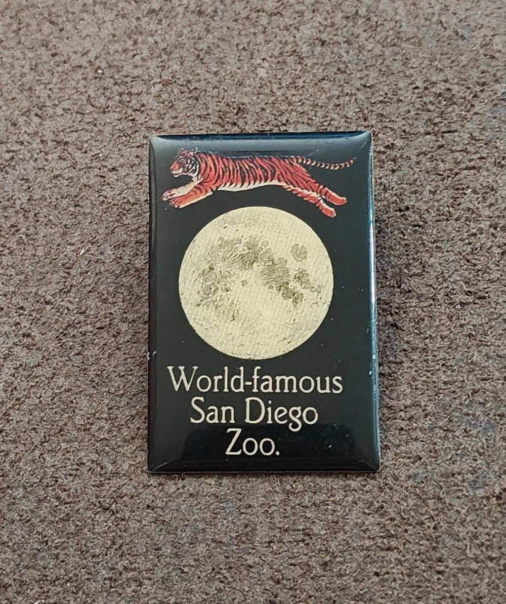 San Diego Zoo enamel pin on carpet with tiger and moon; World-famous San Diego Zoo text