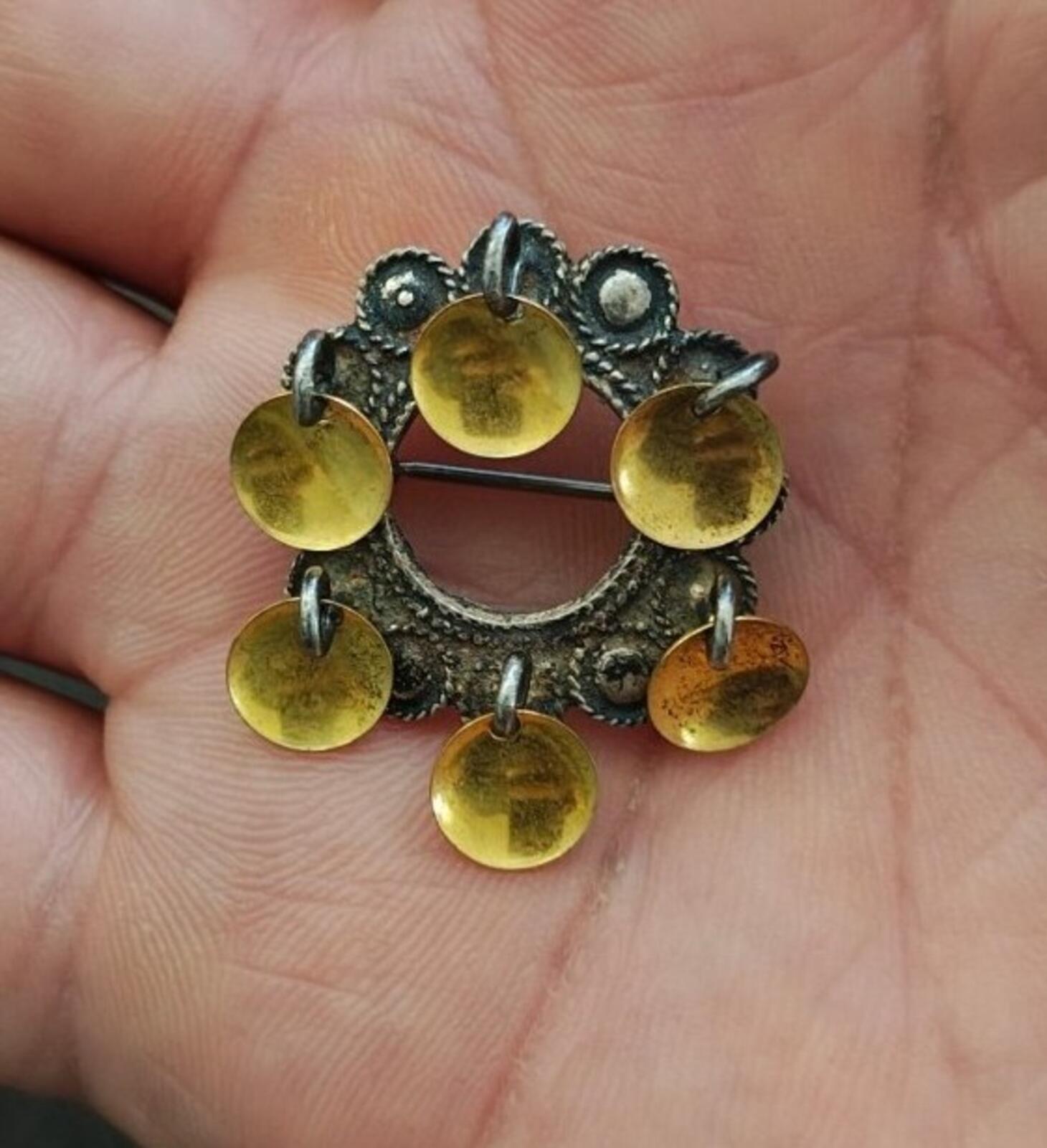 Norwegian brooch with dark silver filigree and dangling gold-toned discs
