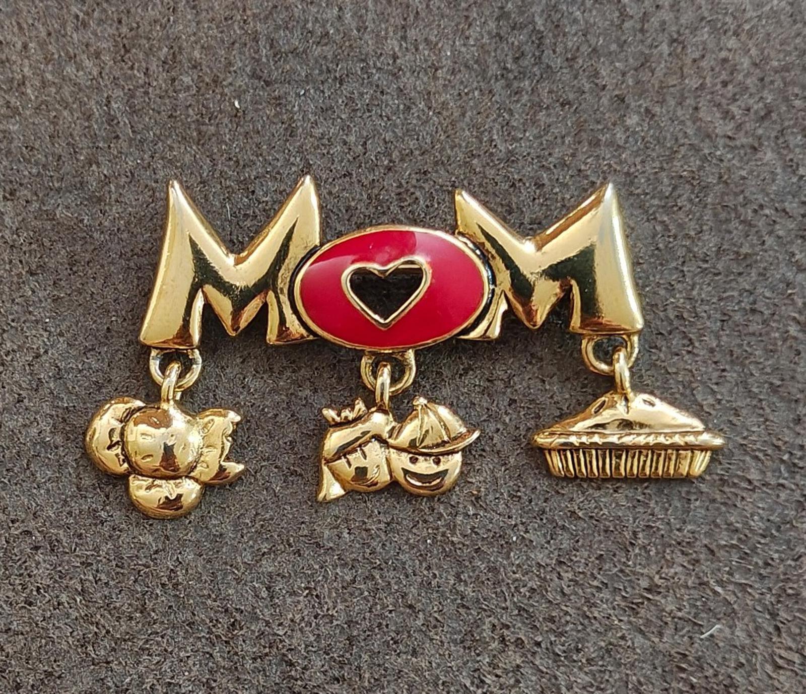 Gold-tone MOM brooch pin with red heart enamel oval and three dangling charm pieces