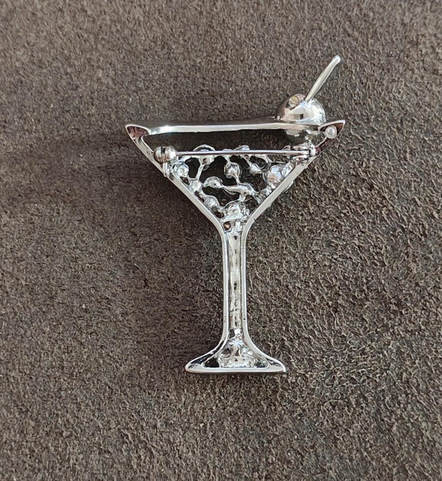 Silver-tone martini glass brooch with green rhinestone cup and openwork crystal pattern