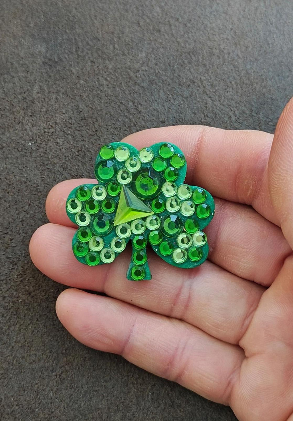 Green rhinestone shamrock brooch pin with three-leaf design and bright green stones