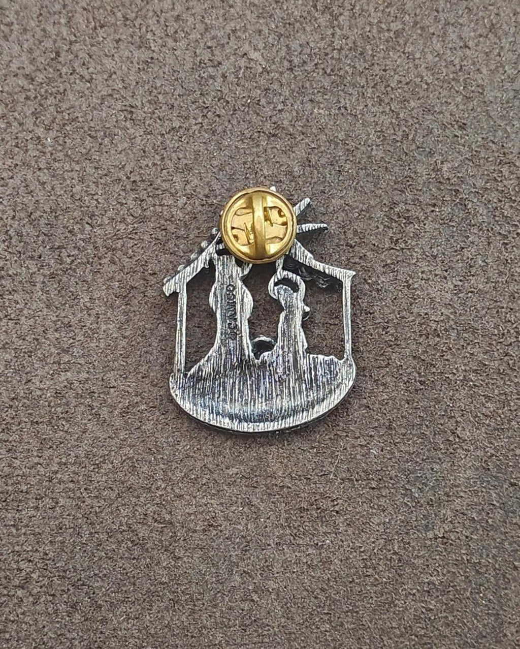 Silver nativity brooch with gold-toned center medallion and rhinestone accents