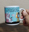 Blue ceramic mug with cartoon rabbits, VCR joke text, and black base border