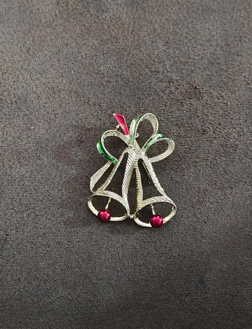 Gold-tone holiday bell brooch with red berry-like beads and green ribbon loops