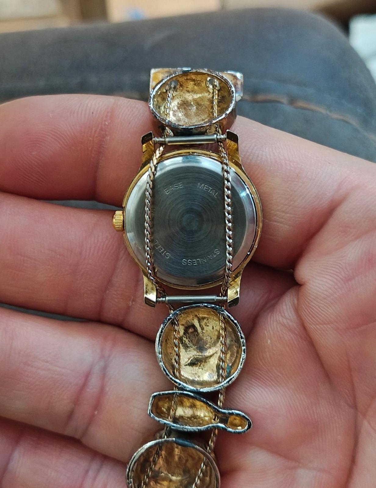 Ladies novelty watch back view with gold-tone chain links and engraved silver-toned case