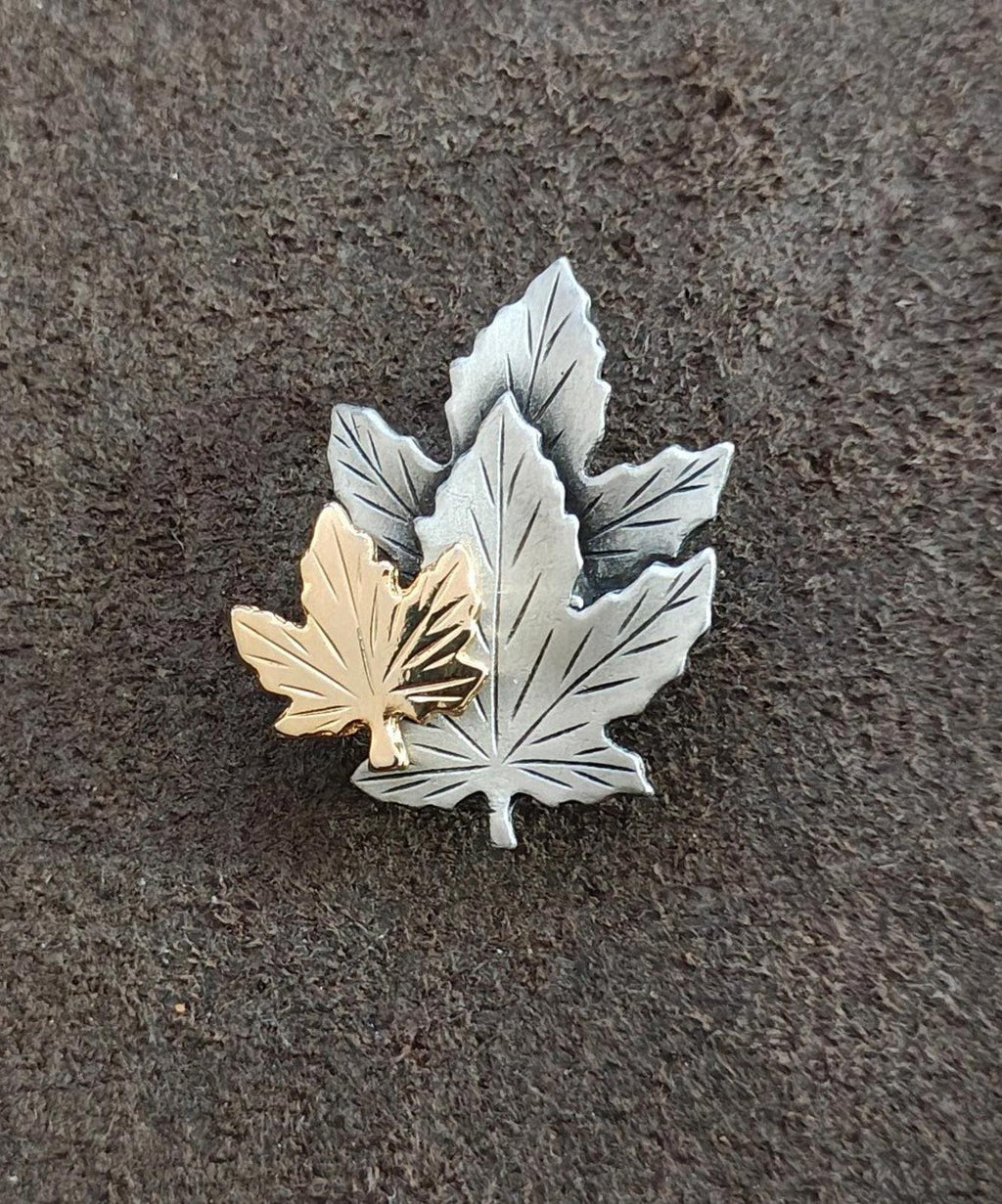 Maple leaf brooch pin, silver-toned with gold-toned left leaf detail