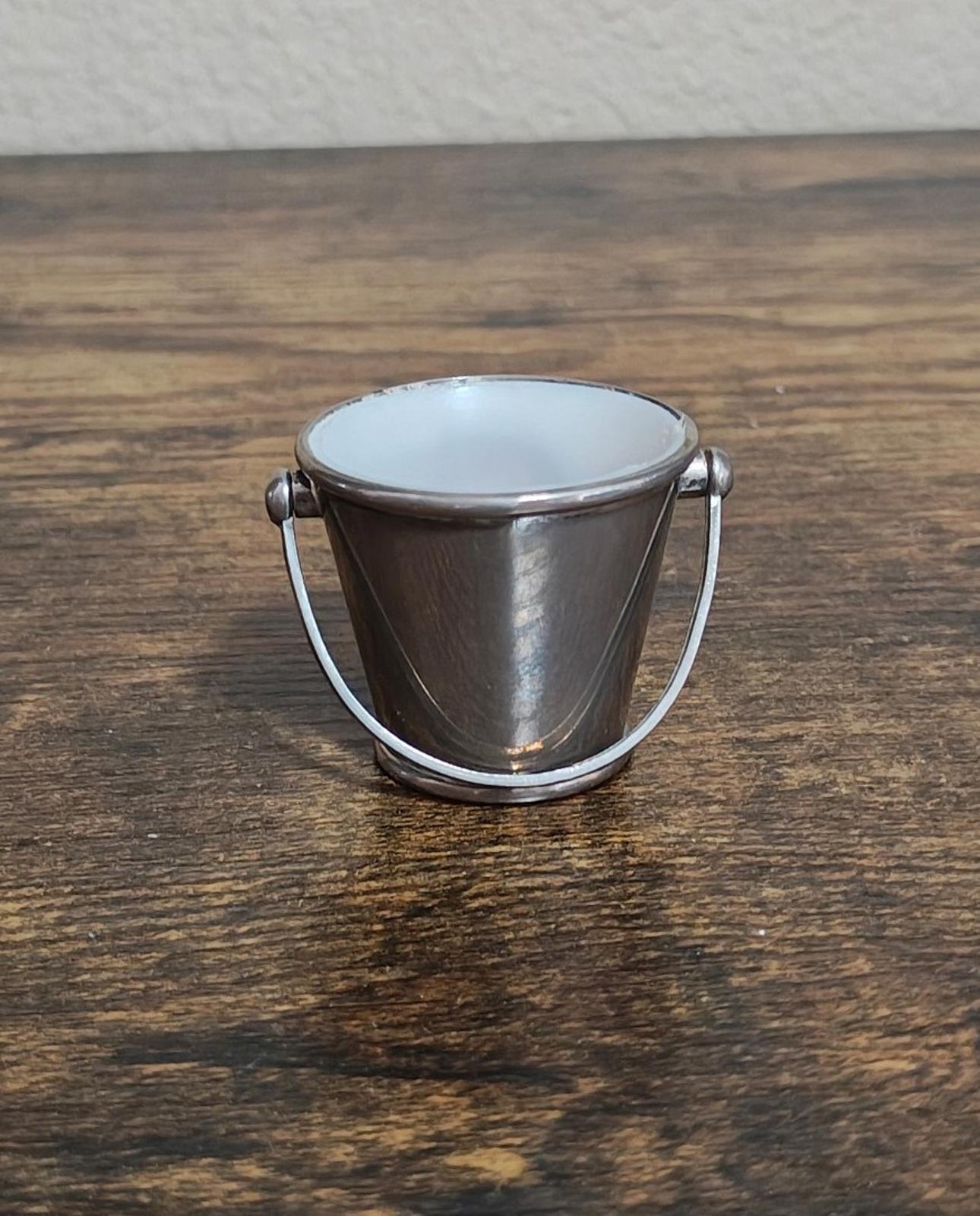 Mini silverplated bucket pail with two loop handles and white interior