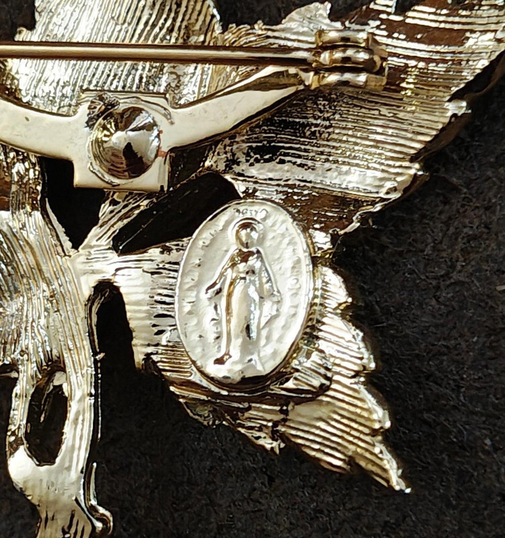 Gold-tone Mary medallion detail with leaf texture on cross pin brooch