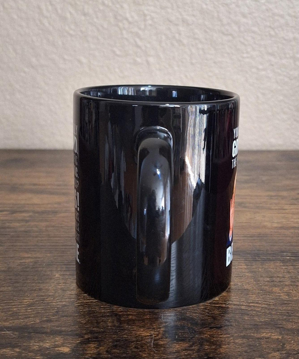 Black ceramic 11 oz mug from side view with glossy finish and empty interior