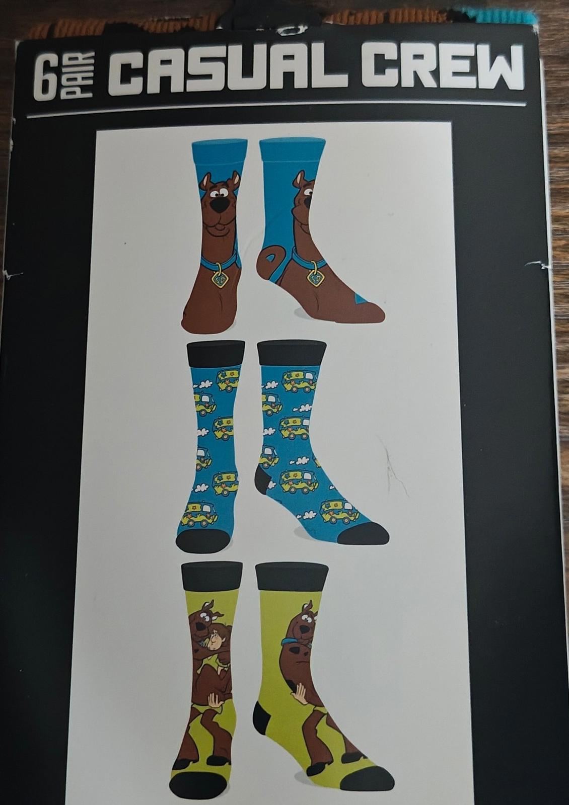 Men's casual crew socks 6-pack front showing six sock designs on box.