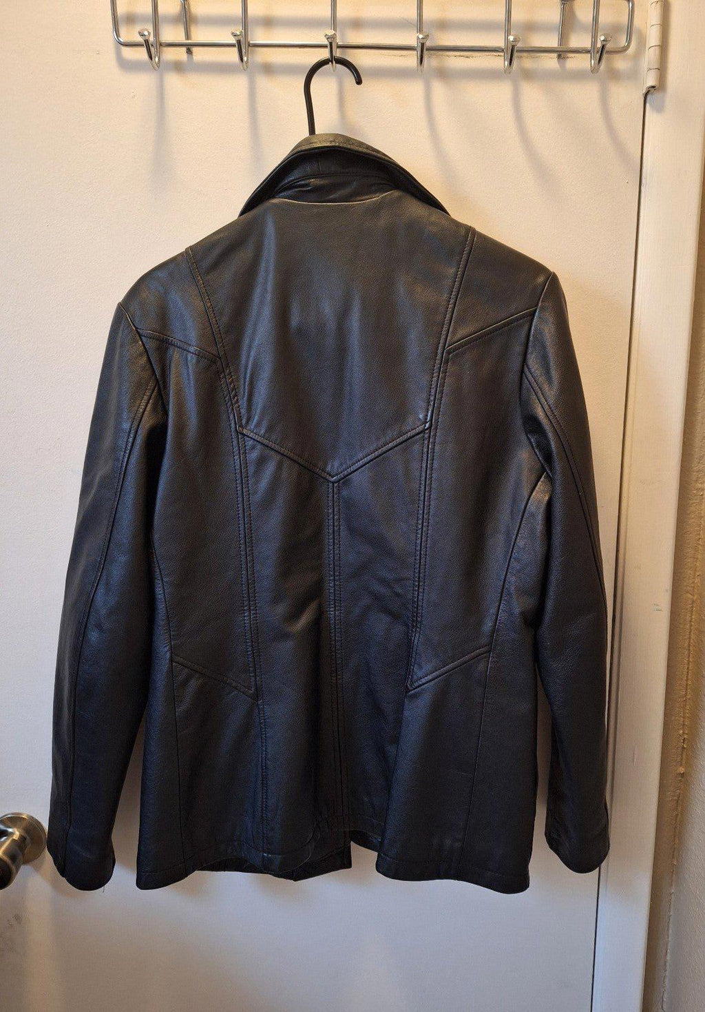 Women's Wilson's Maxima black leather jacket, back view with stitched panel lines