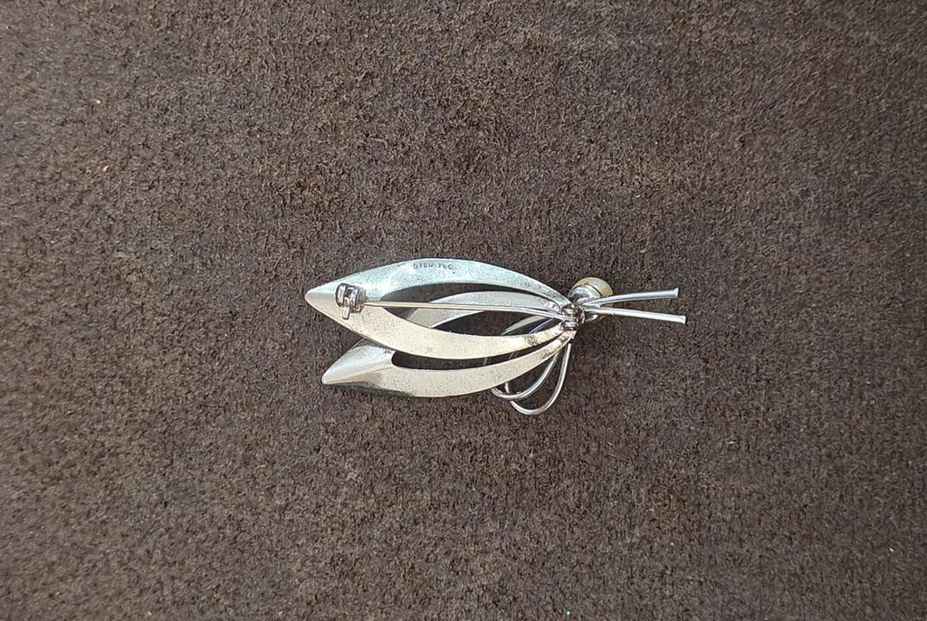 Sterling silver brooch underside with pin and looping wire near cultured pearl