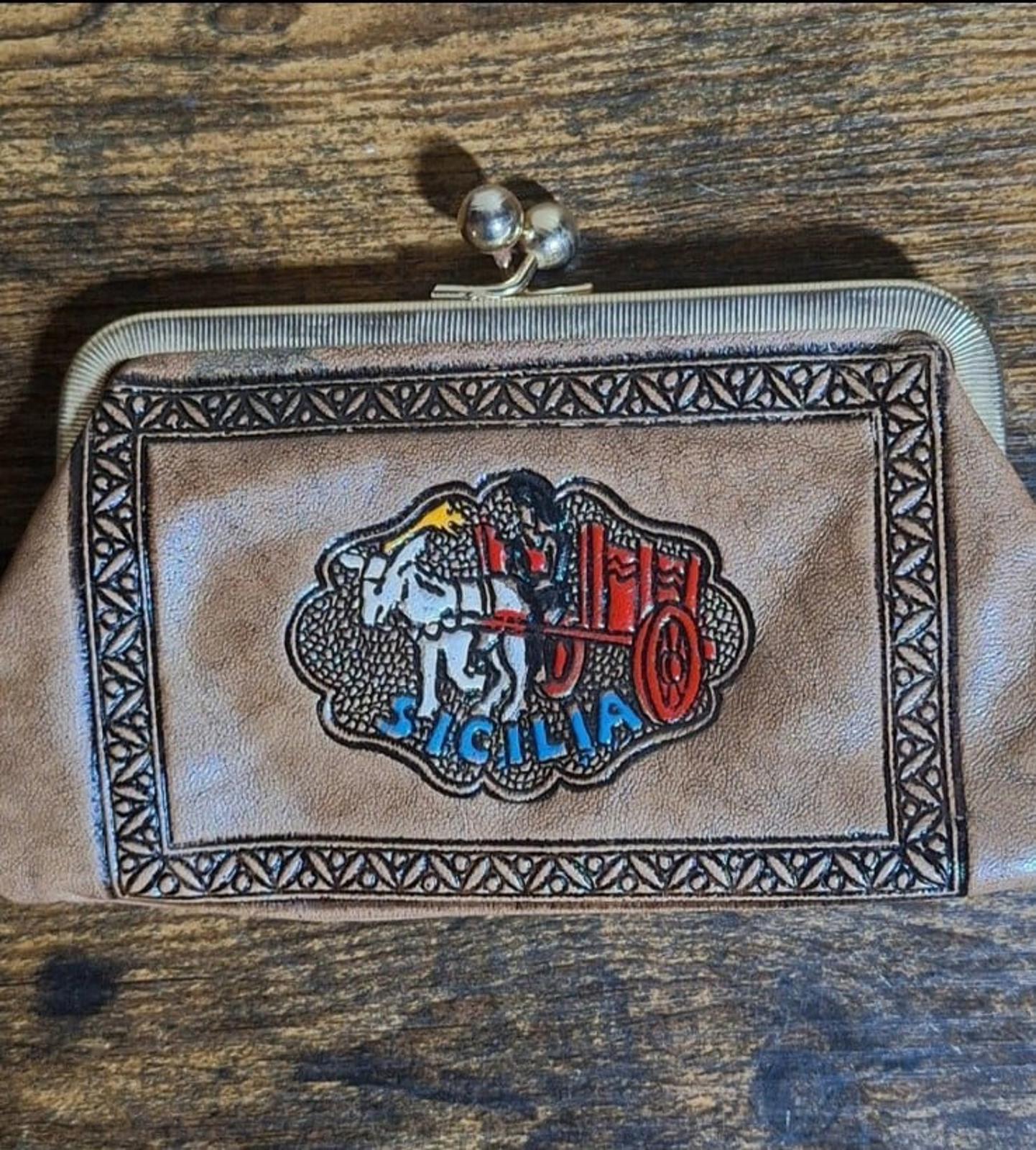 Tan leather coin purse wallet front with Sicily crest emblem in patterned border frame.