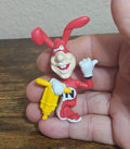 Red PVC cartoon figure in Domino’s worker outfit holding a white chef glove and a yellow tool
