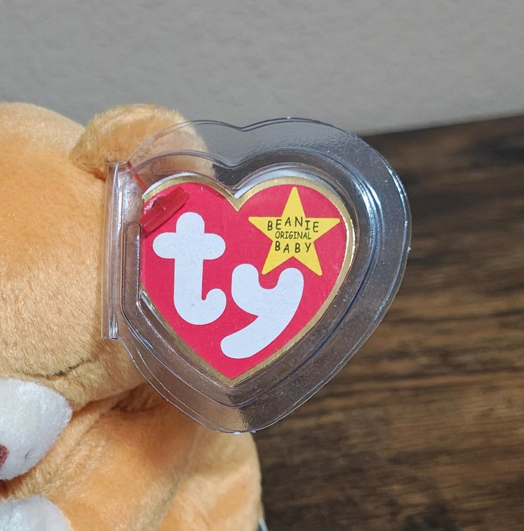 Clear heart Ty tag with Beanie Original Baby logo on brown plush bear
