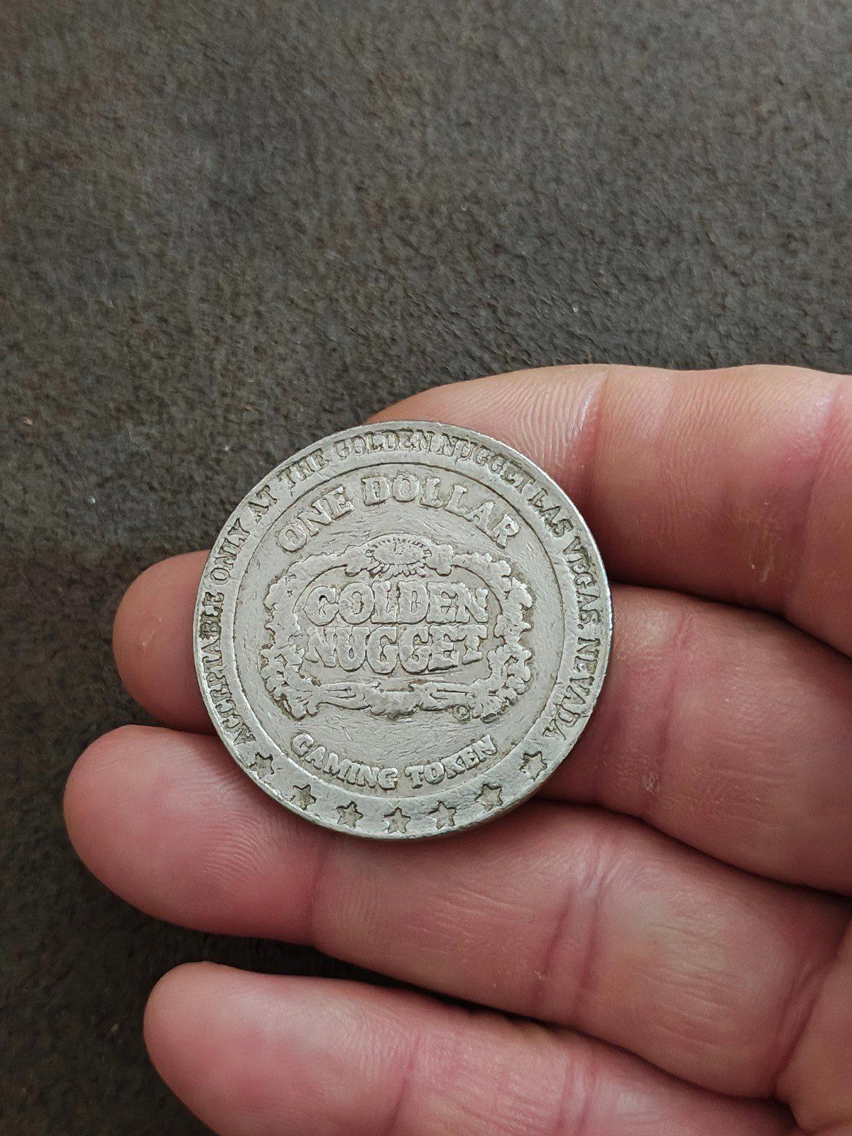 Silver Golden Nugget one-dollar casino token reverse, wreath text including ONE DOLLAR.