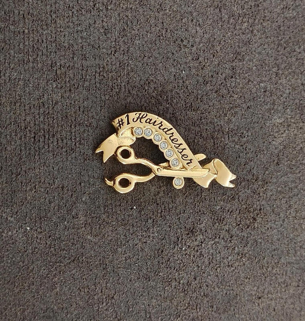 Gold-tone #1 Hairdresser signed brooch with clear rhinestone arc and hairdresser icons