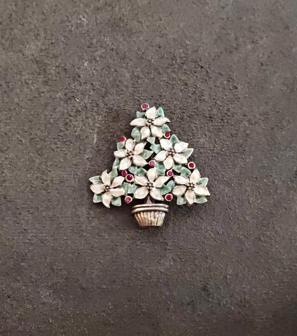 Christmas tree brooch: gold basket, white poinsettias, green leaves, red berry details