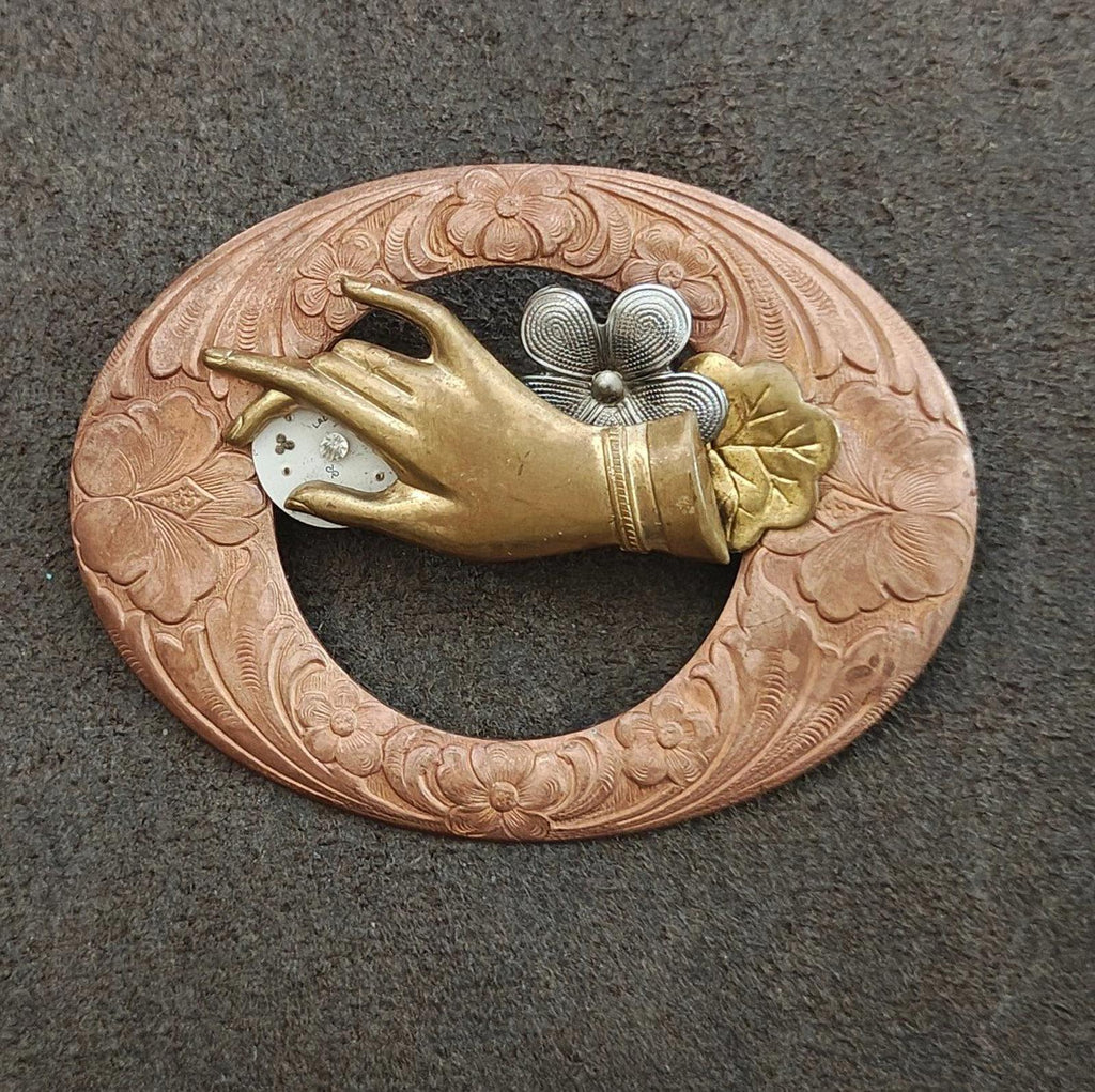 Engraved bronze circular brooch with gold bird centerpiece and gray flower detail