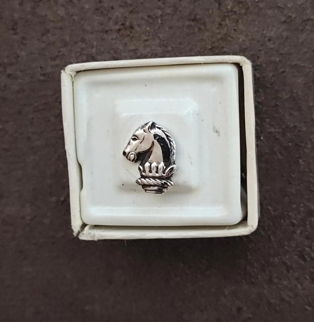Silver-tone horse head tie tack pin centered in bezel with decorative base