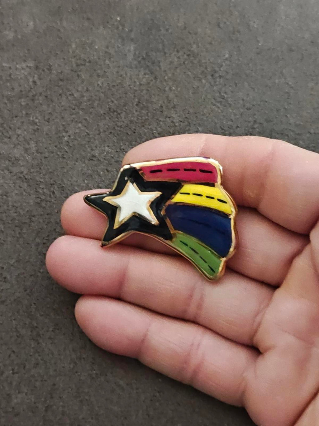 Glazed ceramic shooting star pin brooch with rainbow stripes and gold star detail