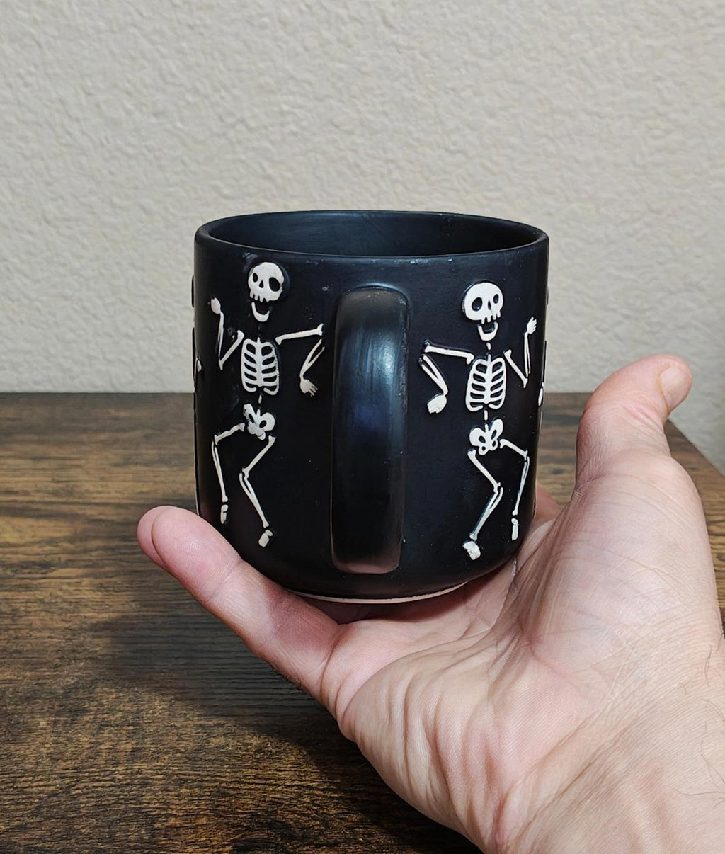 Dancing Skeletons Black Earthenware 13 oz 3D Embossed Black Mug.