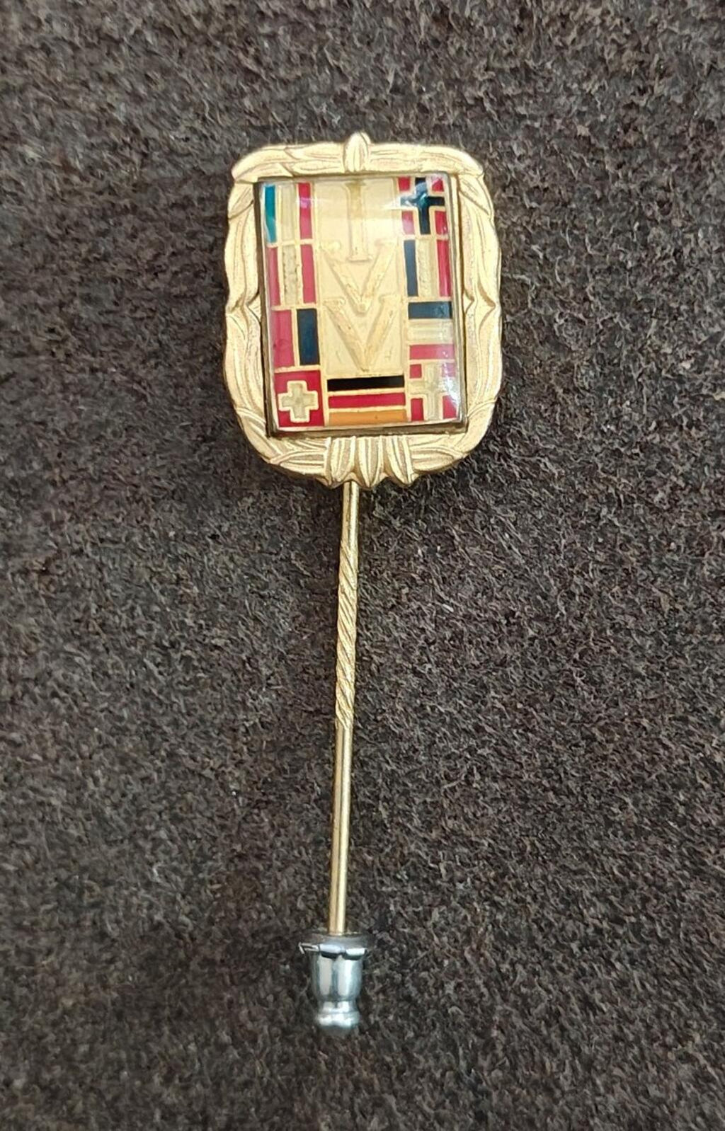 Gold-tone rectangular enamel badge pin with multicolor crest and pin backing
