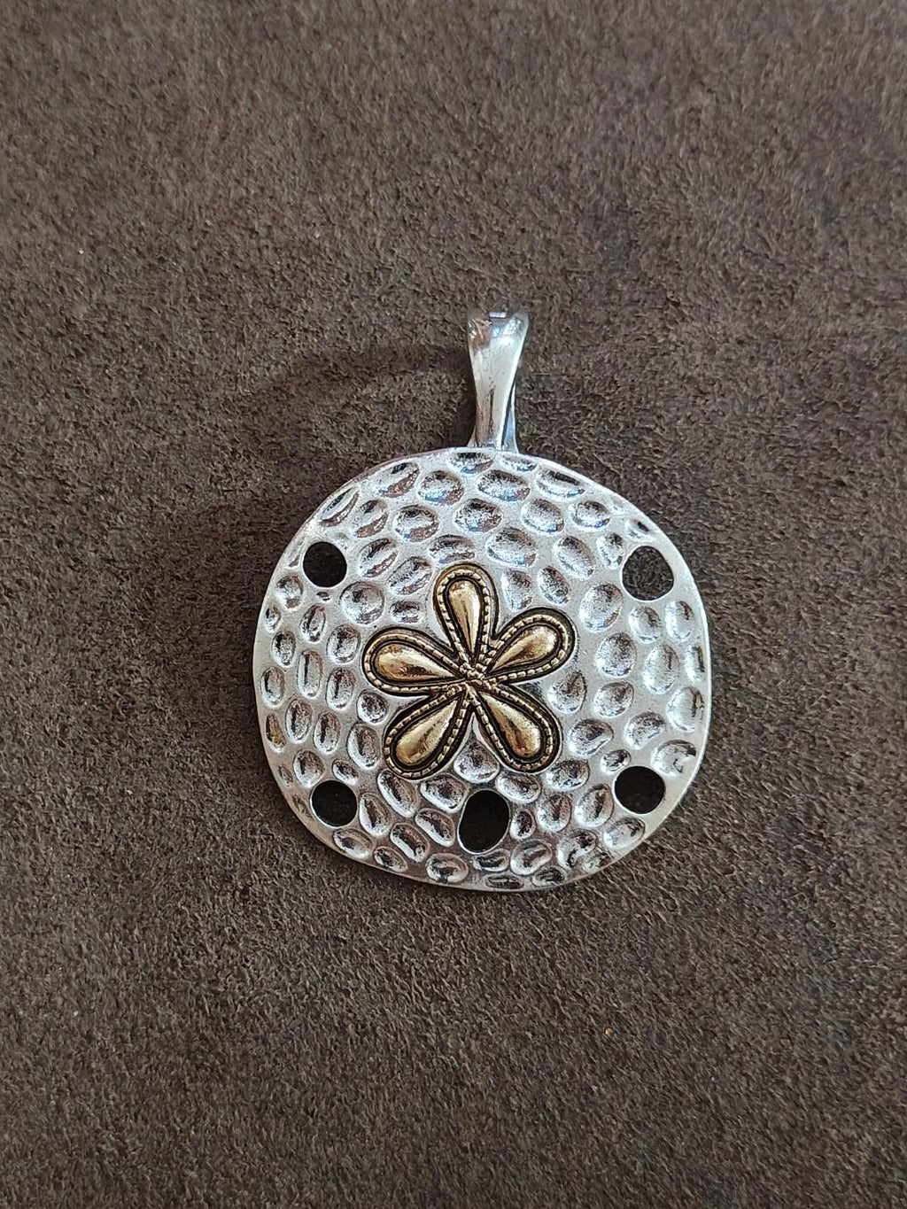 Silver round pendant with perforated dot texture and two-tone flower motif