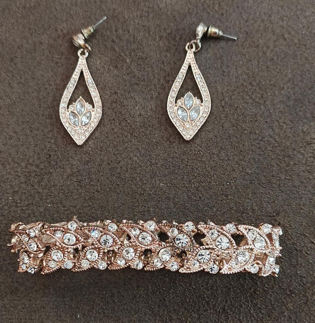Crystal teardrop stud earrings with light blue center stones in silver-tone settings