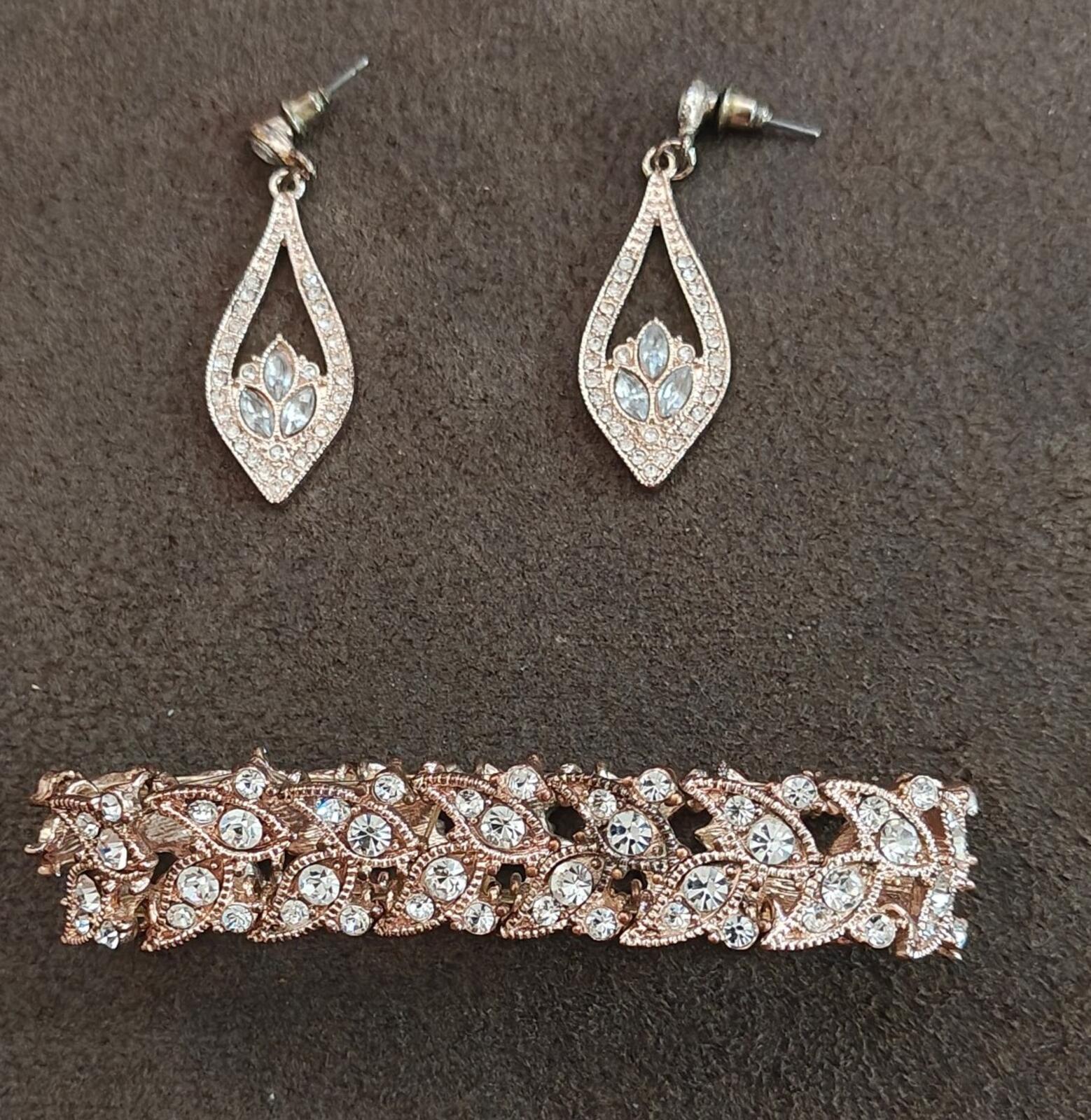 Crystal teardrop stud earrings with light blue center stones in silver-tone settings