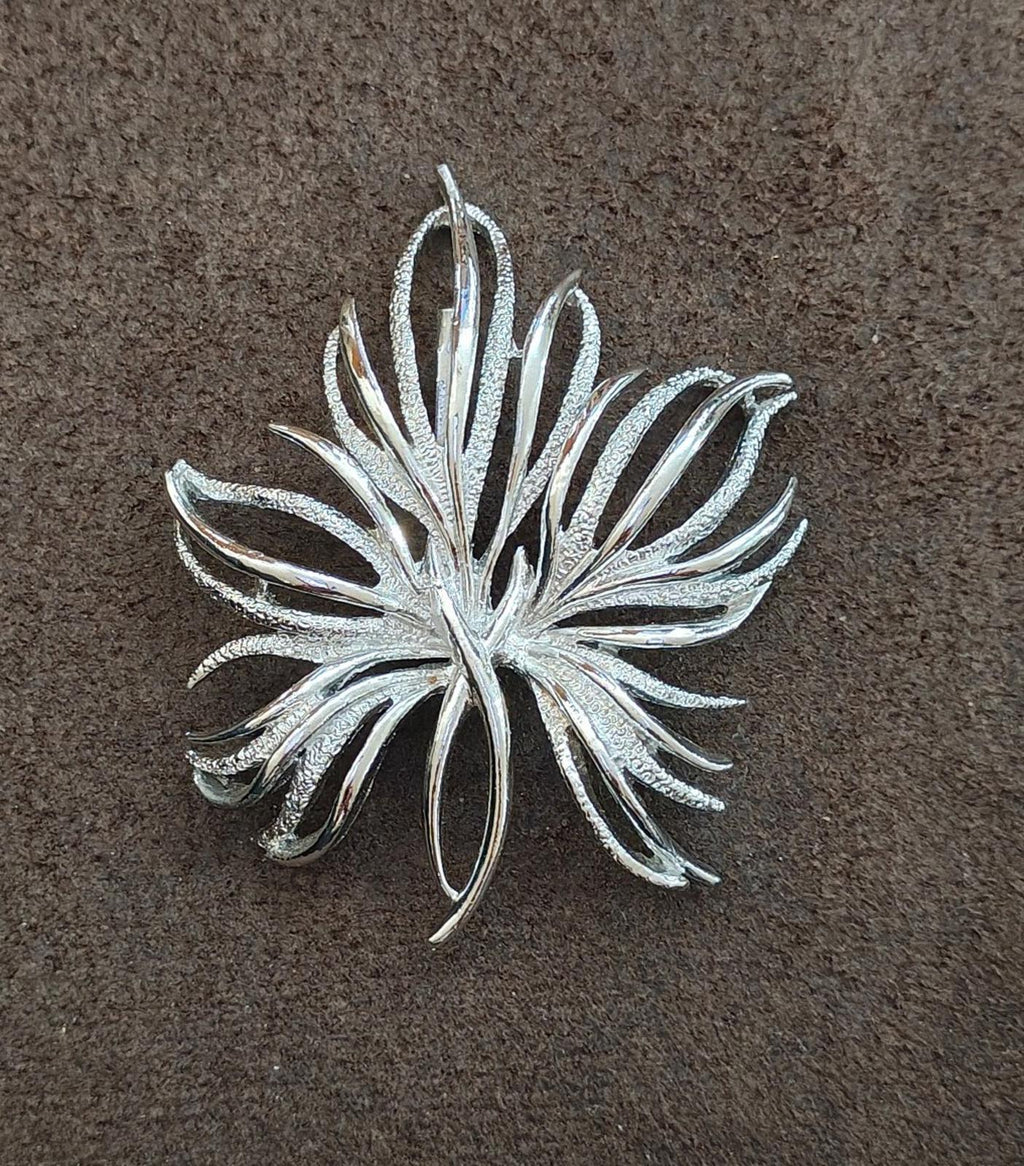 Silver tone leaf pin brooch with frosted texture and central stem, centered view