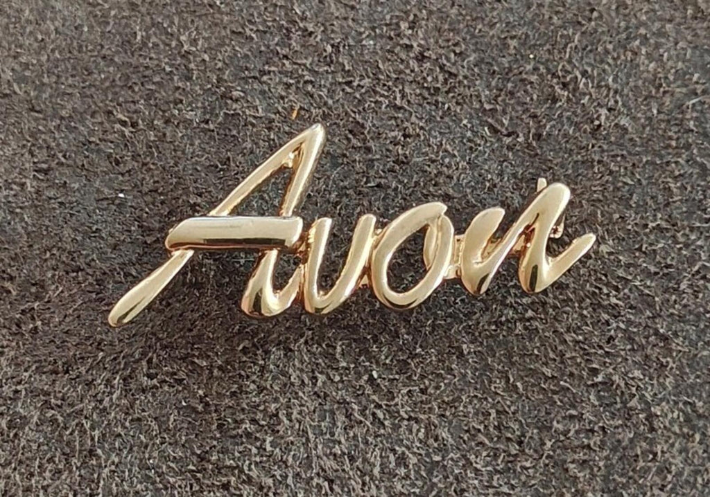 1980s/90s  Avon Gold Tone Cursive Logo Pin